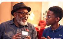 Older and younger generations talking together in a community setting